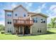 A view of the backyard and rear exterior of the home, including a deck at 9011 Kensington Forest Dr, Harrisburg, NC 28075
