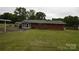 The backyard offers a large grassy area and mature trees at 908 Ravendale Dr, Charlotte, NC 28216