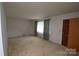 Neutral bedroom with carpet, a window, and a closet offering a serene and inviting atmosphere at 908 Ravendale Dr, Charlotte, NC 28216