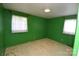 A bright bedroom featuring two windows and a neutral carpet at 908 Ravendale Dr, Charlotte, NC 28216