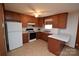 Functional kitchen with updated appliances, wooden cabinets, and a breakfast bar for casual dining at 908 Ravendale Dr, Charlotte, NC 28216