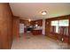 Open floor plan showing the kitchen with wooden cabinets and a spacious living area with classic decor at 908 Ravendale Dr, Charlotte, NC 28216