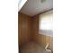 A spare room with wood paneling and natural light at 908 Ravendale Dr, Charlotte, NC 28216