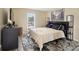 A comfortable bedroom featuring neutral walls, natural light, and modern decorative elements at 9121 Kings Canyon Dr, Charlotte, NC 28210