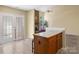 View of the living area with access to the patio and kitchen island, featuring a brick fireplace at 9121 Kings Canyon Dr, Charlotte, NC 28210