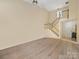 Expansive living room featuring high ceilings, a staircase, and wood-look flooring at 9121 Kings Canyon Dr, Charlotte, NC 28210