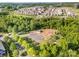 Aerial view of the neighborhood basketball court with mature trees and sidewalks at 915 Claires Creek Ln, Davidson, NC 28036
