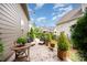 Backyard patio with outdoor furniture, string lights, and manicured landscaping at 915 Claires Creek Ln, Davidson, NC 28036