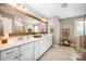 Modern bathroom featuring double sinks, a large mirror, and tile floors at 915 Claires Creek Ln, Davidson, NC 28036