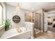 Elegant bathroom with a soaking tub, separate glass-enclosed shower, and stylish decor at 915 Claires Creek Ln, Davidson, NC 28036
