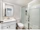 Clean bathroom featuring a shower with glass doors, a toilet, and a sleek vanity sink at 915 Claires Creek Ln, Davidson, NC 28036