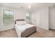 Bright bedroom featuring a comfortable bed and lots of natural light from the windows at 915 Claires Creek Ln, Davidson, NC 28036