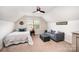 Inviting bedroom featuring a sloped ceiling, a cozy seating area, and ample lighting at 915 Claires Creek Ln, Davidson, NC 28036