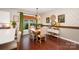 Dining room features elegant decor, wood floors, chandelier, and plenty of natural light at 915 Claires Creek Ln, Davidson, NC 28036