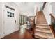 Bright foyer with hardwood floors and staircase leading to the upper level at 915 Claires Creek Ln, Davidson, NC 28036