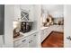 Kitchen view of elegant white cabinetry, a beverage center and open access to the dining and living areas at 915 Claires Creek Ln, Davidson, NC 28036