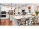 Modern kitchen with white cabinets, stainless steel appliances, island, and hardwood floors at 915 Claires Creek Ln, Davidson, NC 28036