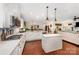 Open kitchen with center island, white cabinets, and modern gas cooktop at 915 Claires Creek Ln, Davidson, NC 28036