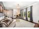 Cozy living room featuring three large windows with custom curtains and a decorative chandelier at 915 Claires Creek Ln, Davidson, NC 28036