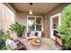 Inviting covered porch with stylish seating, decor, and lots of natural light at 915 Claires Creek Ln, Davidson, NC 28036