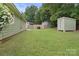 Expansive backyard featuring a storage shed and ample greenery, ideal for outdoor activities at 918 Creekridge Dr, Monroe, NC 28110