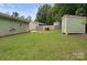 Spacious backyard with lush green lawn and a convenient storage shed at 918 Creekridge Dr, Monroe, NC 28110