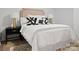 Beautifully decorated bedroom featuring a stylish headboard, black and white pillows and a modern nightstand at 918 Creekridge Dr, Monroe, NC 28110