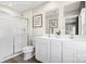 The bathroom has double sinks, wood flooring, and a glass-enclosed shower at 10108 Florentine Way, Charlotte, NC 28214