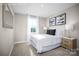 Well-lit bedroom with a white bed, neutral walls, and a large window offering a serene and peaceful setting at 10108 Florentine Way, Charlotte, NC 28214