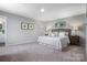 Cozy main bedroom featuring neutral walls, a comfortable bed, decorative pillows, and bedside tables with lamps at 10108 Florentine Way, Charlotte, NC 28214