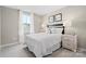 Serene bedroom with neutral decor, a comfortable bed with white bedding, bedside tables, and plenty of natural light at 10108 Florentine Way, Charlotte, NC 28214