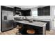A kitchen with a center island, granite countertops, stainless steel appliances, and modern black cabinets at 10108 Florentine Way, Charlotte, NC 28214