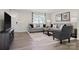 Comfortable living room featuring gray sofas, a coffee table, a media console, and ample natural light at 10108 Florentine Way, Charlotte, NC 28214