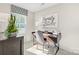 Bright home office featuring a wooden desk, stylish chair, natural light, and minimalist decor at 10108 Florentine Way, Charlotte, NC 28214