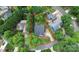 Aerial view of a charming home with a well-manicured lawn, beautiful trees, and a long driveway at 10449 Quiet Bay Ct, Charlotte, NC 28278