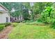 Beautiful backyard with lush greenery, landscaping, and a stepping stone path at 10449 Quiet Bay Ct, Charlotte, NC 28278