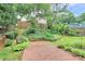 Backyard with lush greenery and a brick path at 10449 Quiet Bay Ct, Charlotte, NC 28278