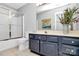 Well-lit bathroom featuring a shower-tub combo and vanity with shaker cabinets at 10449 Quiet Bay Ct, Charlotte, NC 28278