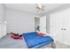 bedroom featuring a bed, airplane ceiling fan, and staircase at 10449 Quiet Bay Ct, Charlotte, NC 28278