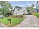 Two-story home with a well-manicured lawn, featuring a spacious driveway and convenient two-car garage at 10449 Quiet Bay Ct, Charlotte, NC 28278