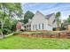 Two-story home featuring a stone porch, dormer windows, and a neatly landscaped yard for a welcoming curb appeal at 10449 Quiet Bay Ct, Charlotte, NC 28278