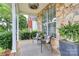 Cozy front porch with stone accents, comfortable seating, and a decorative rug, perfect for relaxing outdoors at 10449 Quiet Bay Ct, Charlotte, NC 28278