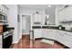 Bright kitchen features updated appliances, white cabinetry, and dark counters at 10449 Quiet Bay Ct, Charlotte, NC 28278