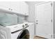 Convenient laundry room featuring a Samsung washer and dryer and ample storage cabinets at 10449 Quiet Bay Ct, Charlotte, NC 28278