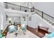 Open-concept living room with soaring ceilings, hardwood floors, a fireplace, and a view of the dining area at 10449 Quiet Bay Ct, Charlotte, NC 28278