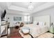 Relaxing main bedroom with hardwood floors, tray ceilings and stylish chandelier lighting at 10449 Quiet Bay Ct, Charlotte, NC 28278