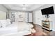 Bright main bedroom with ensuite bathroom access, large screen TV, and stylish decor at 10449 Quiet Bay Ct, Charlotte, NC 28278