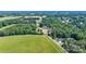 Aerial view of a countryside home surrounded by lush trees and serene landscapes at 105 Saddlewood Ln, Statesville, NC 28625