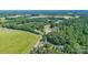 Aerial view of a countryside home surrounded by verdant trees and peaceful scenery at 105 Saddlewood Ln, Statesville, NC 28625