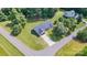 Aerial view of a single-story home with a long driveway surrounded by lush greenery at 105 Saddlewood Ln, Statesville, NC 28625